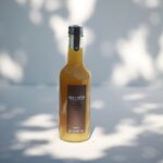 Alain Milliat pineapple juice 330ml bottle displayed in soft natural light in a lifestyle setting
