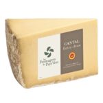 Front view of a 1.3 kg wedge of Les Fromagers du Pays Vert Cantal Entre-Deux PDO cheese with the product label, isolated on a white background.