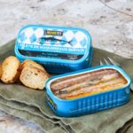 Ferrigno Mackerel Fillets in Spring Water 125g shown in an open tin with sliced bread